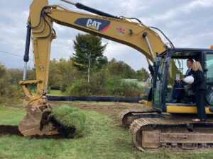Supervisor kicks off groundbreaking ceremony with an excavator - Town of Moreau Sewer Extension Groundbreaking